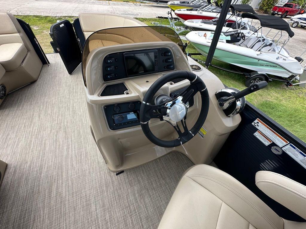 Slide: The Image of 2022 Manitou 18 Aurora LE Standard Twin Tube boat interior with steering console. - 15