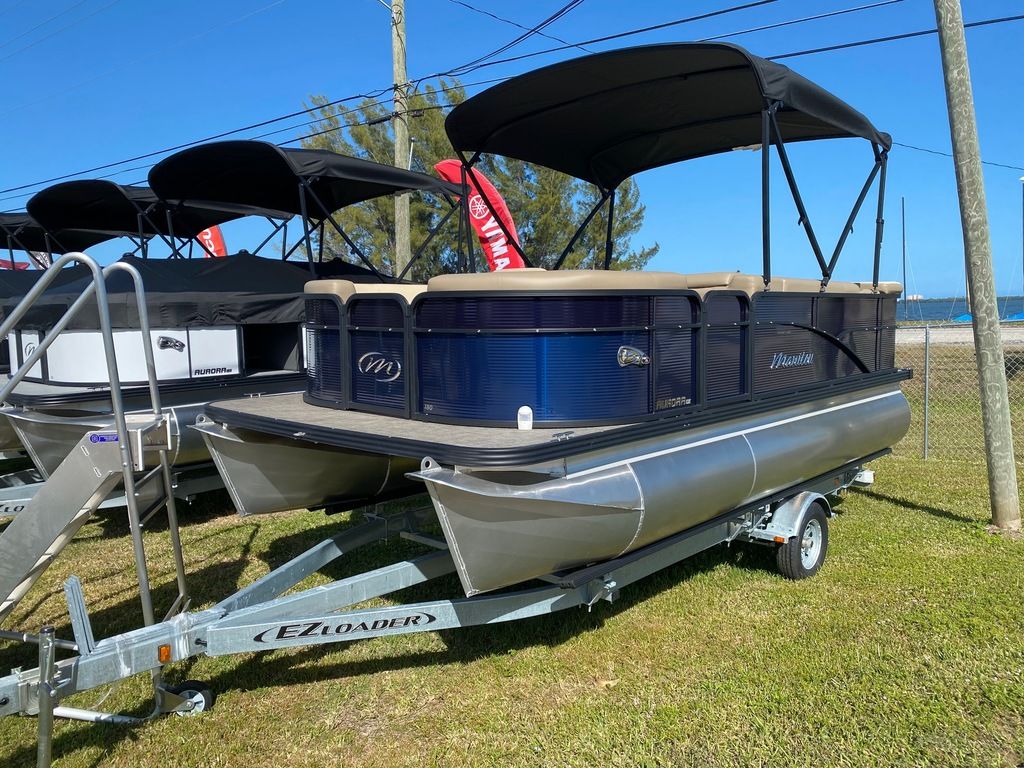 Slide: The Image of 2022 Manitou 18 Aurora LE Standard Twin Tube pontoon boat on EZ Loader trailer. - 17