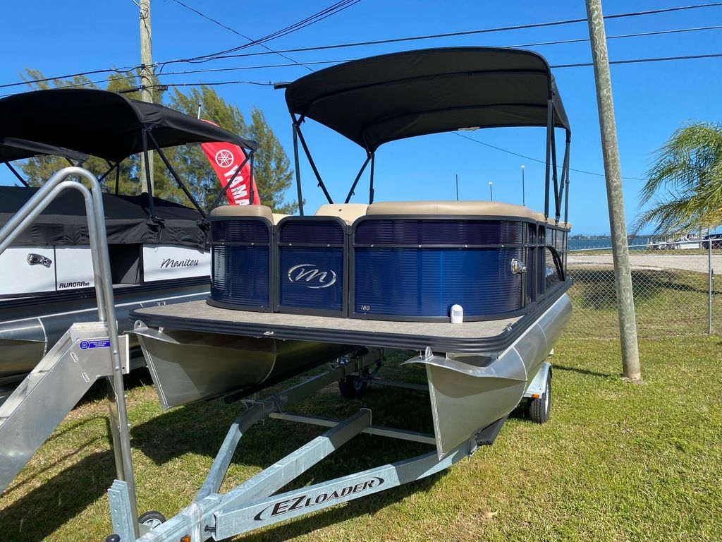 Slide: The Image of 2022 Manitou 18 Aurora LE Standard Twin Tube pontoon boat on trailer. - 18