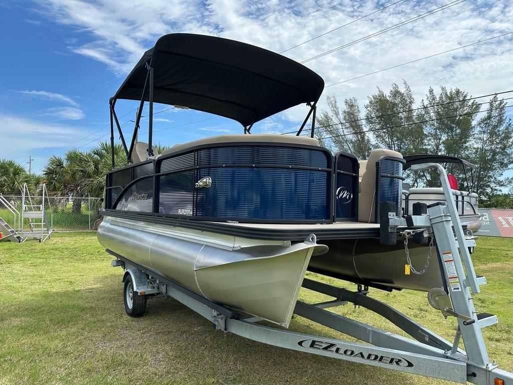 Slide: The Image of 2022 Manitou 18 Aurora LE Standard Twin Tube pontoon boat on EZ Loader trailer. - 2