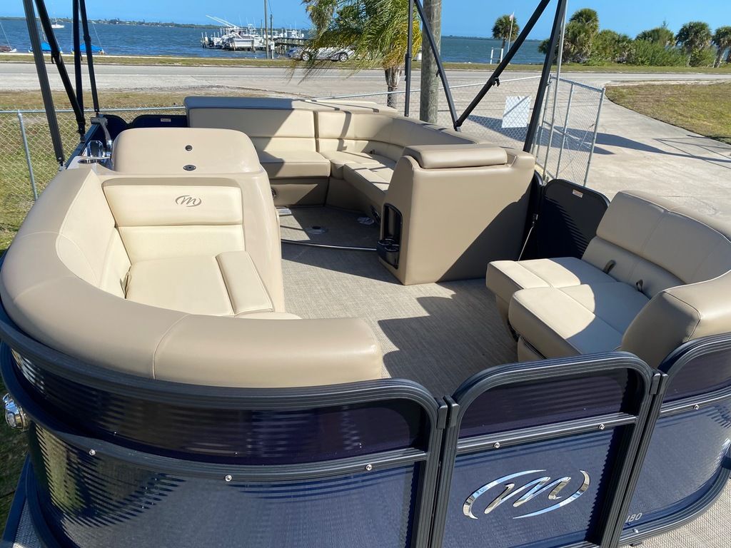 Slide: The Image of 2022 Manitou 18 Aurora LE Standard Twin Tube pontoon boat with beige seating. - 20