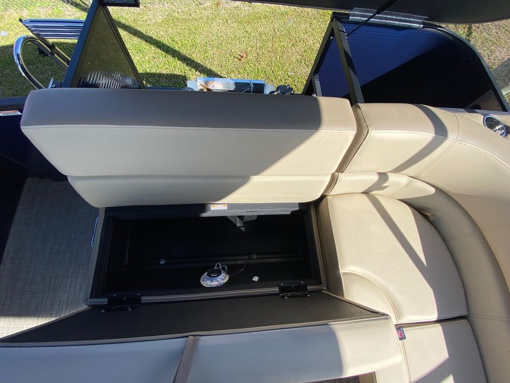 Slide: The Image of 2022 Manitou 18 Aurora LE Standard Twin Tube boat with open storage compartment. - 22