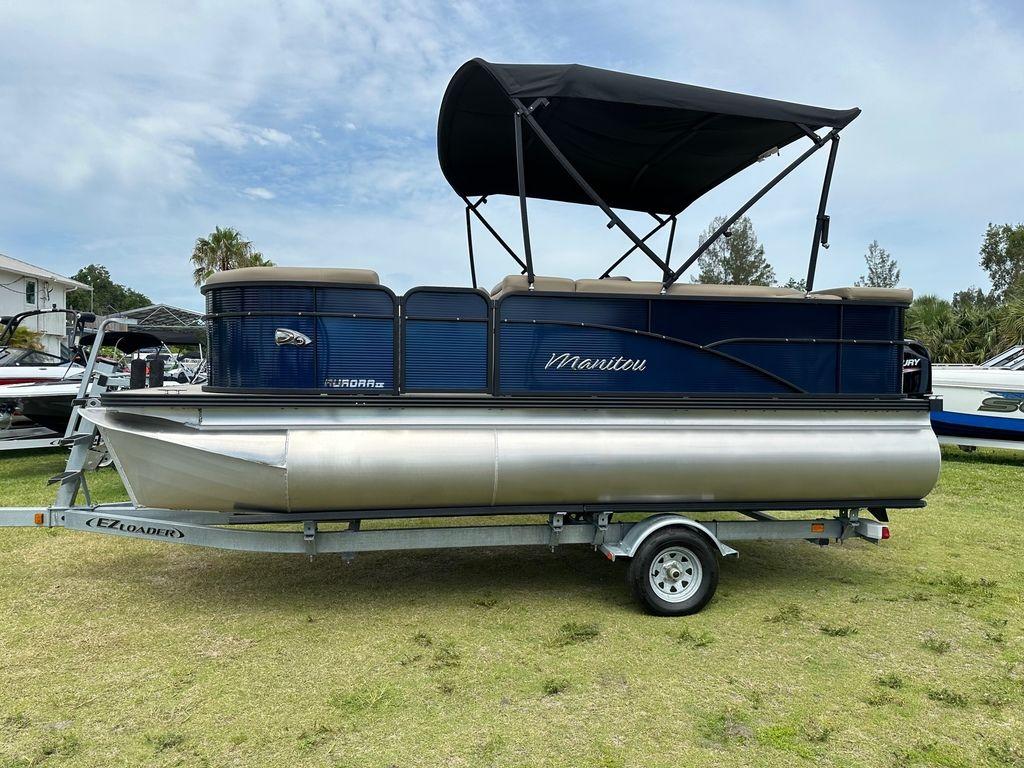 Slide: The Image of 2022 Manitou 18 Aurora LE Standard Twin Tube pontoon boat on trailer. - 6