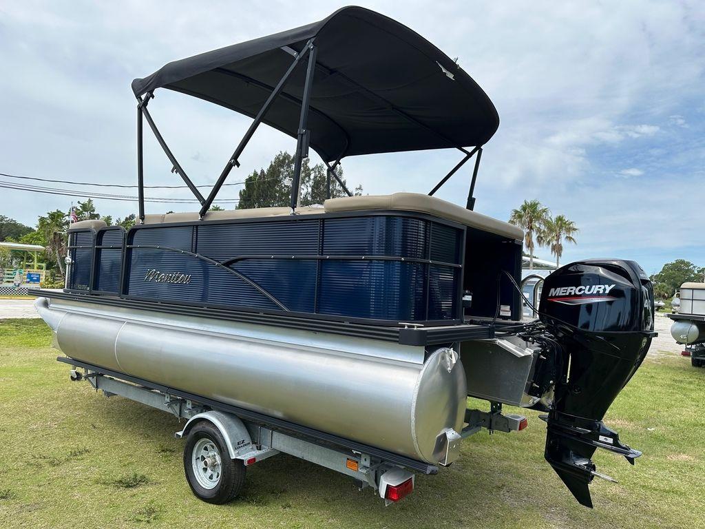 Slide: The Image of 2022 Manitou 18 Aurora LE Standard Twin Tube pontoon boat with Mercury outboard motor. - 8