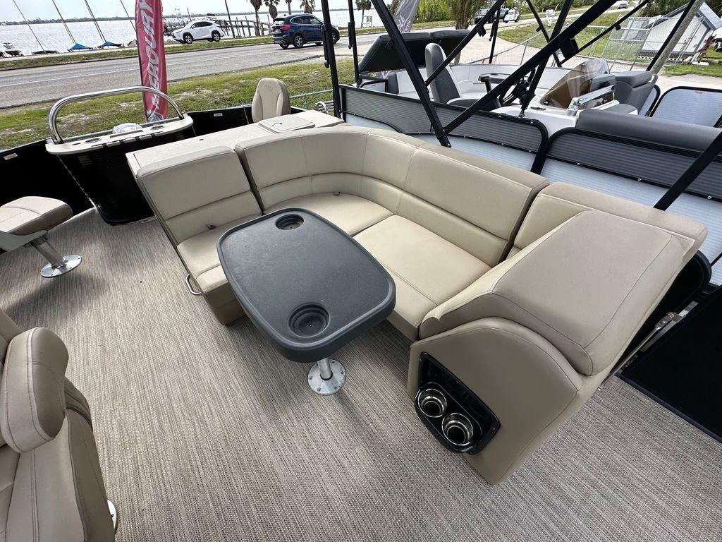 Slide: The Image of 2022 Manitou 20 Aurora LE Angler Full Front Twin Tube interior with beige seating and table. - 12
