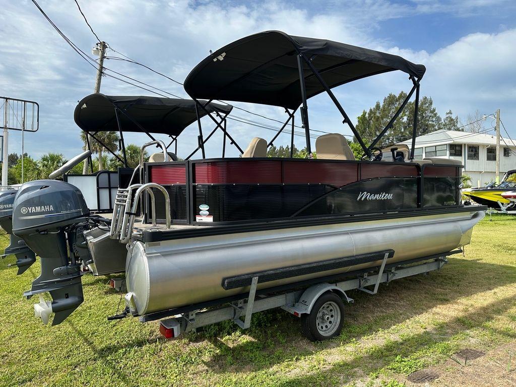 Slide: The Image of 2022 Manitou 20 Aurora LE Angler Full Front Twin Tube pontoon boat on trailer. - 2