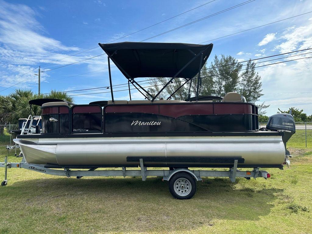 Slide: The Image of 2022 Manitou 20 Aurora LE Angler Full Front Twin Tube pontoon boat on trailer. - 6