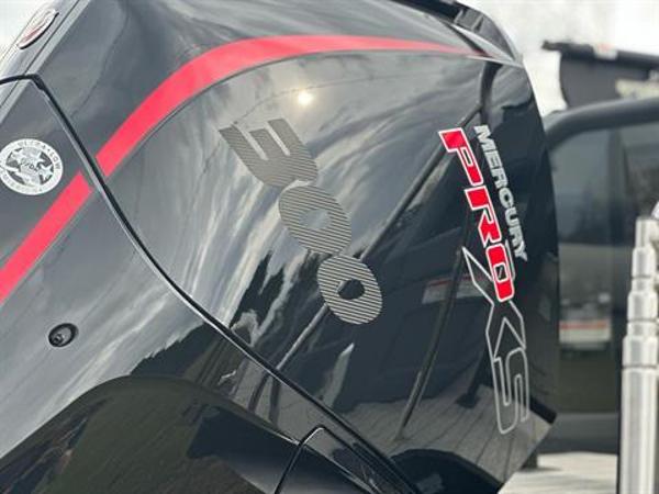 Slide: The Image of 2024 Manitou 24 Explore with Mercury Pro XS 300 outboard engine. - 3