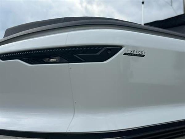 Slide: The Image of 2024 Manitou 24 Explore boat, sleek white exterior with modern design. - 5