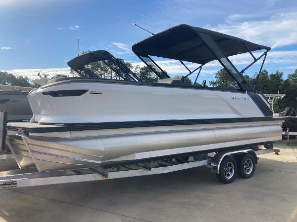 Slide: The Image of 2024 Manitou 24 EXPLORE SWITCHBACK pontoon boat on a trailer. - 1