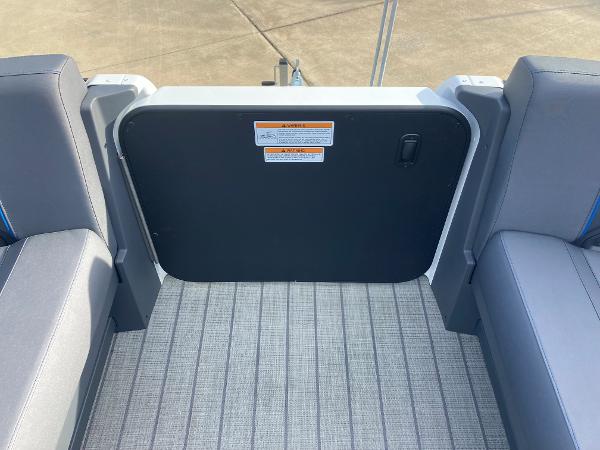 Slide: The Image of 2024 Manitou 24 EXPLORE SWITCHBACK boat interior seating and rear gate. - 13