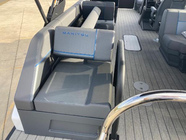 Slide: The Image of 2024 Manitou 24 EXPLORE SWITCHBACK boat interior with gray seating and blue accents. - 21