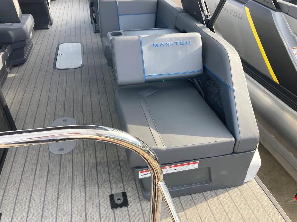 Slide: The Image of 2024 Manitou 24 EXPLORE SWITCHBACK boat interior with gray seating and deck. - 22