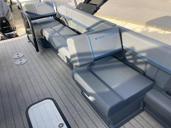 Slide: The Image of 2024 Manitou 24 EXPLORE SWITCHBACK boat interior with gray seating and blue accents. - 7