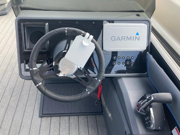 Slide: The Image of 2024 Manitou 24 EXPLORE SWITCHBACK dashboard with Garmin navigation system. - 9