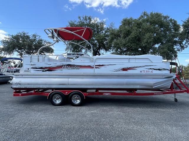 Slide: The Image of 2008 Manitou 24 X-Plode Cruise pontoon boat on red trailer, parked outdoors. - 1