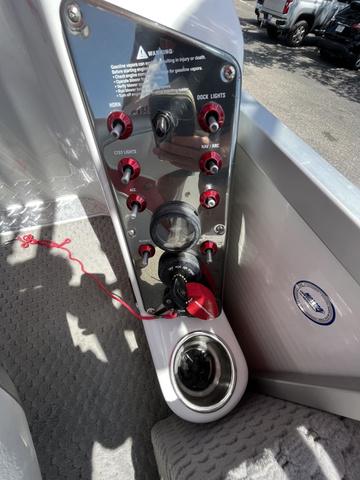 Slide: The Image of Control panel of 2008 Manitou 24 X-Plode Cruise boat with switches and ignition. - 12