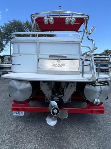 Slide: The Image of 2008 Manitou 24 X-Plode Cruise pontoon boat, rear view with propeller and red accents. - 4