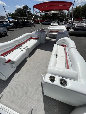 Slide: The Image of 2008 Manitou 24 X-Plode Cruise boat with white and red seating, docked outdoors. - 6