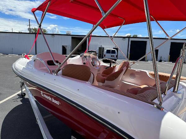 Slide: The Image of 2025 MarinBoat Tango with red canopy, parked outdoors, showcasing sleek design and comfortable seating. - 10