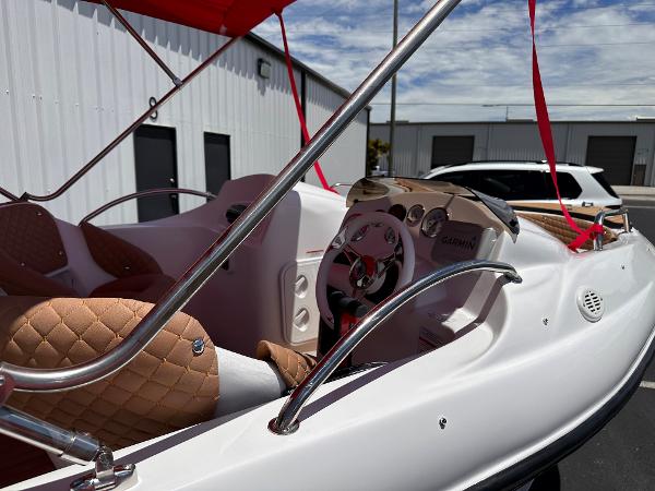 Slide: The Image of 2025 MarinBoat Tango interior with tan quilted seats and sleek steering wheel design. - 7