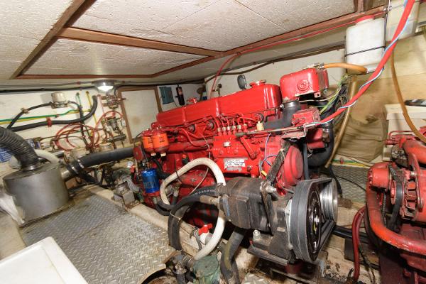 Slide: The Image of Engine room of 1983 Marine Trader 40 Double Cabin with red machinery and wiring. - 23