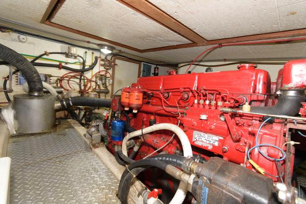 Slide: The Image of Engine room of 1983 Marine Trader 40 Double Cabin with red machinery and piping. - 24