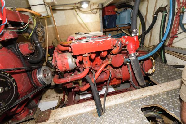 Slide: The Image of Engine room of 1983 Marine Trader 40 Double Cabin with red machinery and piping. - 25