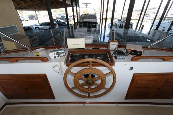 Slide: The Image of 1983 Marine Trader 40 Double Cabin helm with wooden wheel and navigation instruments. - 9