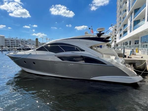 Slide: The Image of 2008 Marquis 40 SC yacht docked at a marina on a sunny day. - 0