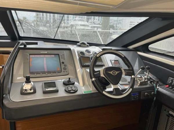Slide: The Image of 2008 Marquis 40 SC yacht helm with advanced navigation controls and steering wheel. - 1