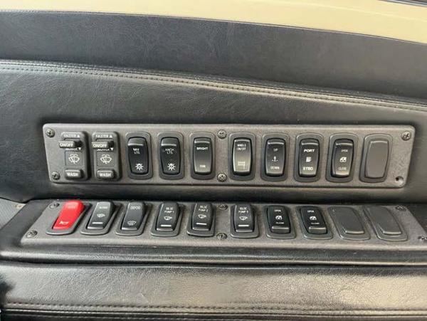 Slide: The Image of Control panel of a 2008 Marquis 40 SC yacht with various switches and buttons. - 19
