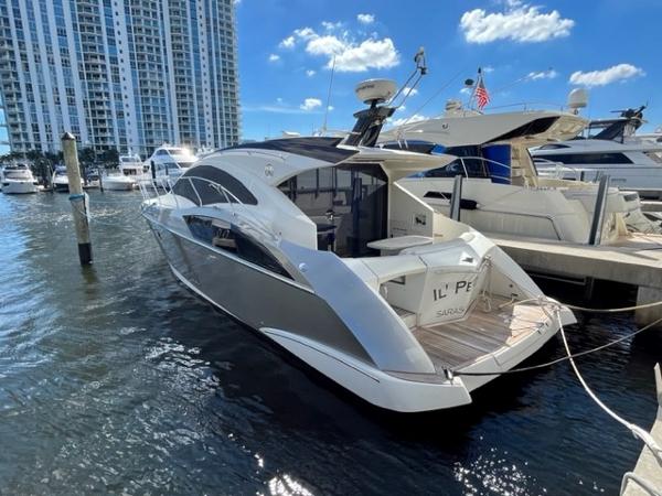 Slide: The Image of 2008 Marquis 40 SC yacht docked at marina with cityscape background. - 3