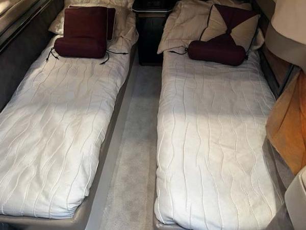 Slide: The Image of Twin beds in the 2008 Marquis 40 SC yacht cabin, with white bedding and decorative pillows. - 47