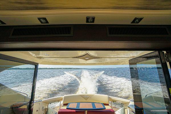 Slide: The Image of View from the 2009 Marquis 500 Sport Coupe yacht's interior, overlooking the wake on open water. - 12