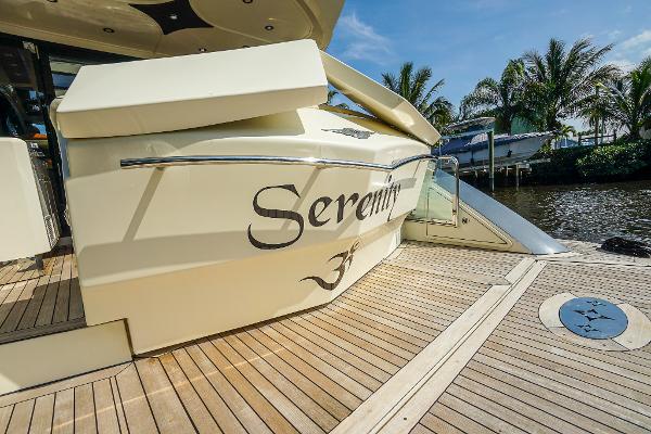 Slide: The Image of 2009 Marquis 500 Sport Coupe yacht named Serenity docked by palm trees. - 13