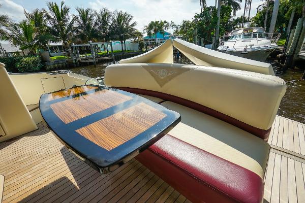 Slide: The Image of Luxury seating area on 2009 Marquis 500 Sport Coupe yacht with wooden table. - 16