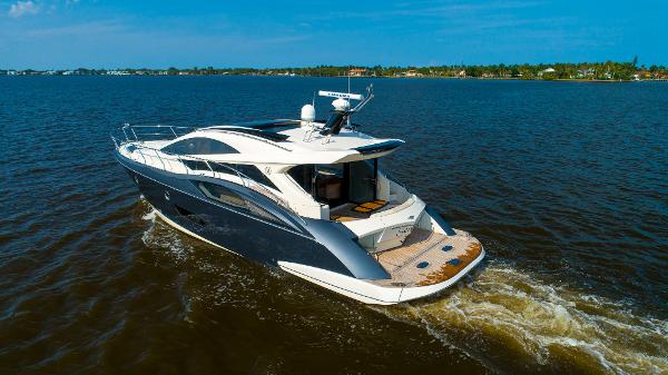Slide: The Image of 2009 Marquis 500 Sport Coupe yacht cruising on open water. - 2