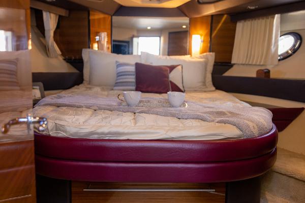 Slide: The Image of Luxurious bedroom in a 2009 Marquis 500 Sport Coupe yacht with cozy bedding. - 37