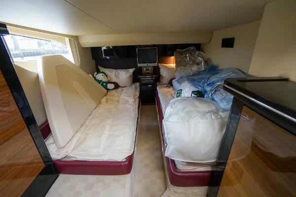 Slide: The Image of 2009 Marquis 500 Sport Coupe interior cabin with twin beds and storage. - 40