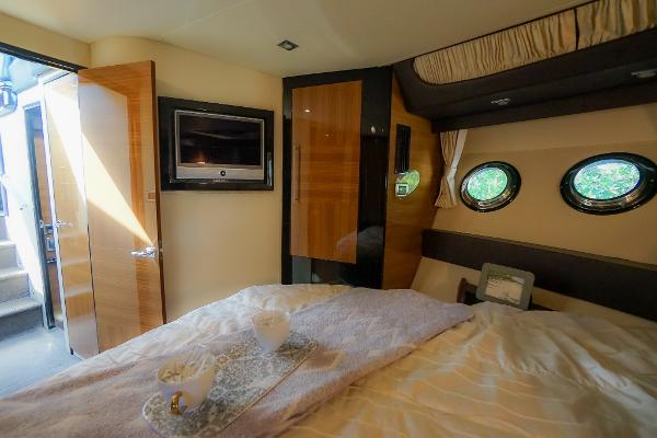 Slide: The Image of Luxurious bedroom in 2009 Marquis 500 Sport Coupe yacht with TV and porthole windows. - 45