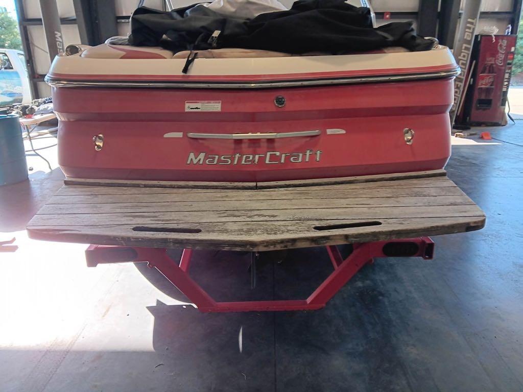 Slide: The Image of 2007 MasterCraft X15 boat rear view in a garage. - 13