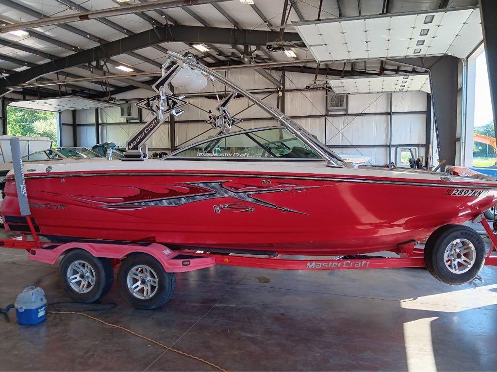 Slide: The Image of 2007 MasterCraft X15 red boat on trailer in indoor storage facility. - 15