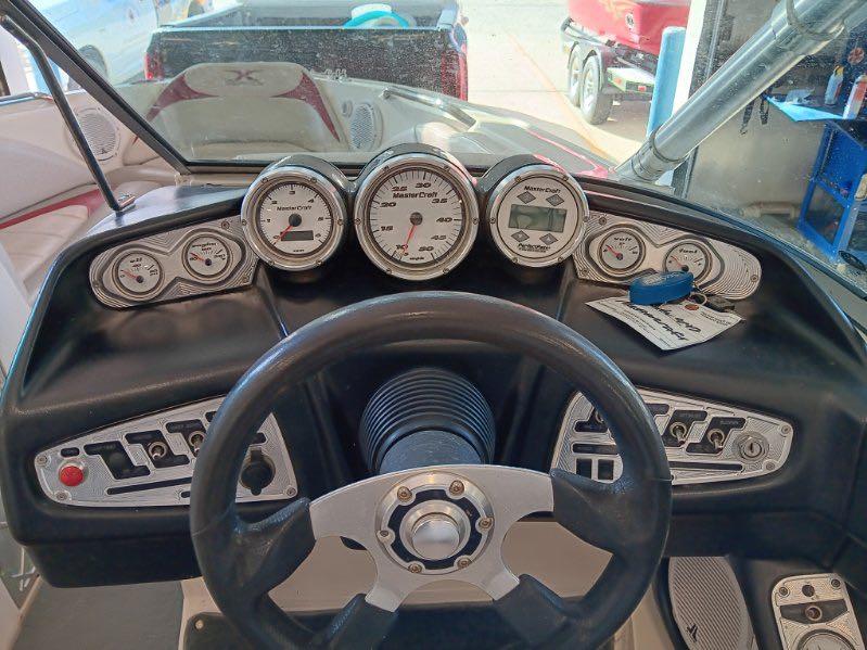 Slide: The Image of 2007 MasterCraft X15 boat dashboard with gauges and steering wheel. - 16