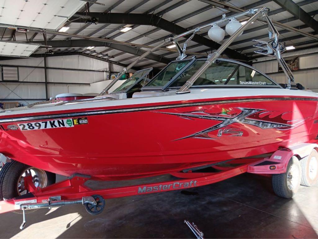 Slide: The Image of 2007 MasterCraft X15 red boat in indoor storage. - 2