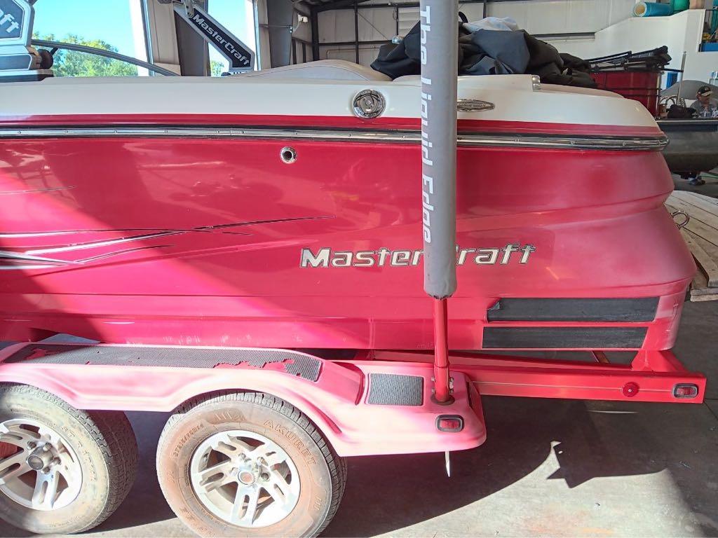 Slide: The Image of 2007 MasterCraft X15 red boat on trailer in a garage. - 5
