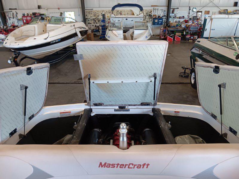 Slide: The Image of 2007 MasterCraft X15 boat engine compartment open in a workshop. - 6