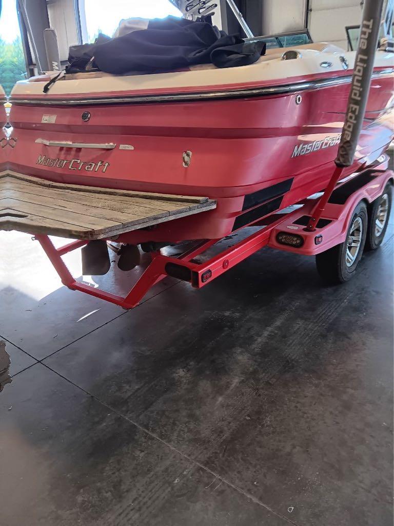 Slide: The Image of 2007 MasterCraft X15 boat on a red trailer in a garage. - 7