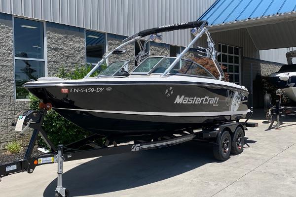 Slide: The Image of 2009 MasterCraft X15 boat on trailer outside a building. - 1