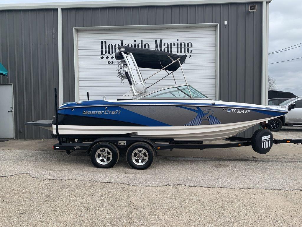 Slide: The Image of 2012 MasterCraft X2 boat on a trailer in front of Dockside Marine. - 0